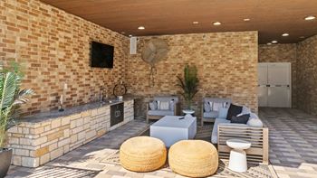 A patio with a fireplace and seating area.